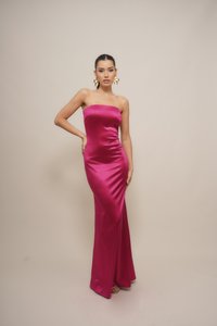 Fitted, strapless evening gown in vibrant pink satin, featuring a smooth texture and a floor-length design with subtle draping at the waist.