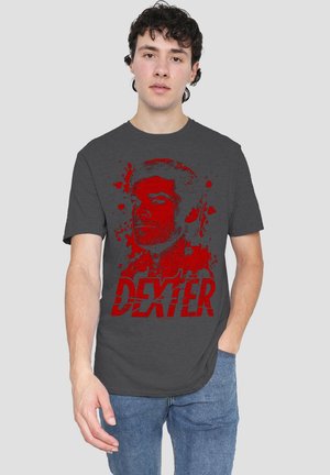 Gray cotton t-shirt featuring a red graphic print of a character's face and the word "DEXTER" in bold, distressed lettering.