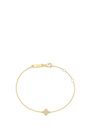 Delicate gold chain bracelet with a small clover-shaped charm encrusted with clear gemstones and a lobster clasp closure.