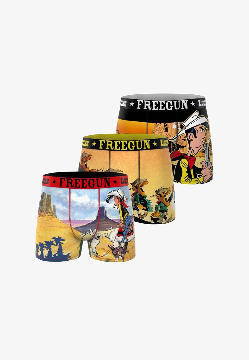 Trois boxers colorés avec des personnages de cow-boy dessin animé et des paysages désertiques, avec des ceintures de marque "FREEGUN" en rouge, jaune et noir.