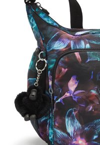 Floral-patterned black fabric bag featuring vibrant blue and purple flowers. Includes a black plush gorilla charm and silver hardware details.