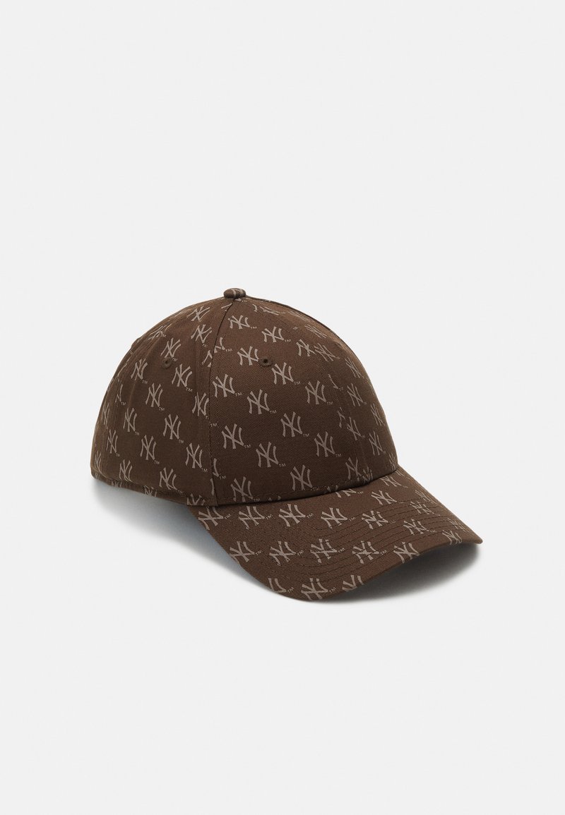 Brown baseball cap made of fabric, featuring a repeated light brown NY logo pattern, with a curved brim and adjustable back strap.