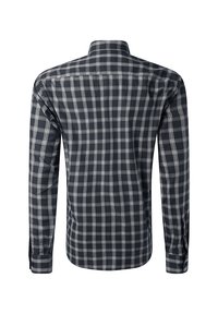 Camicetta a maniche lunghe a quadri in bianco e nero vista da dietro, con colletto classico e polsini abbottonati.