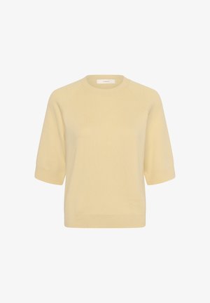 Világos bézs rövid ujjú kötött pulóver bordázott mandzsettákkal, szegéllyel és kerek nyakkivágással, fehér háttéren bemutatva.