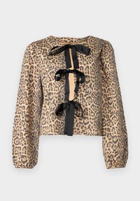 Blusa cropped em padrão de onça com mangas longas, apresentando laços de fita preta na parte da frente e um tecido liso e texturizado.