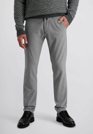 Grijze broek met een gladde textuur, rechte pasvorm en subtiele designdetails, gecombineerd met zwarte leren schoenen met decoratieve perforaties.