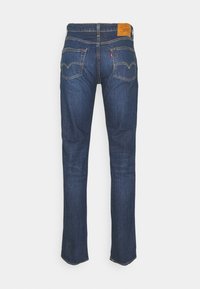 Dark blue straight-leg jeans with back pockets, tan stitching, and a brown leather Levi's patch at the waistband.