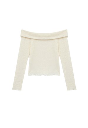 Top de hombros caídos y manga larga en tela texturizada color crema con patrón ondulado y dobladillo con volantes en los puños y la parte inferior.