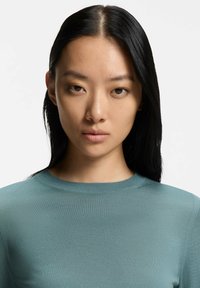 Licht turquoise langärmeliges Oberteil mit rundem Hals, aus geripptem Stoff gefertigt, bietet eine figurbetonte Silhouette und subtile Nähte.