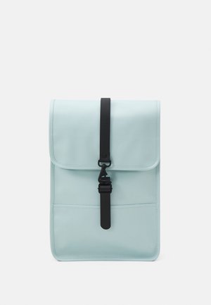 Sac à dos rectangulaire bleu clair avec rabat et boucle de sangle noire verticale centrée sur un fond clair uni.