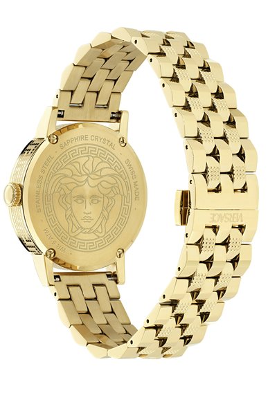 Kuldne roostevaba terasest kell mustriga rihmaga, safiirkristalliga ja medaljonilaadse tagaküljega, millel on näo disain.