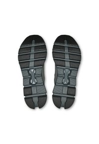 Melnas sporta apavu zoles ar teksturētām saķeres rakstām, kas satur horizontālas rievas un nostiprinātas zonas, paredzētas stabilitātei un saķerei.