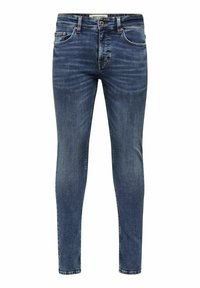 Jeans de denim azul de corte slim con un acabado desgastado, cinco bolsillos y acentos de herrajes metálicos. Detalles de costura en las costuras.