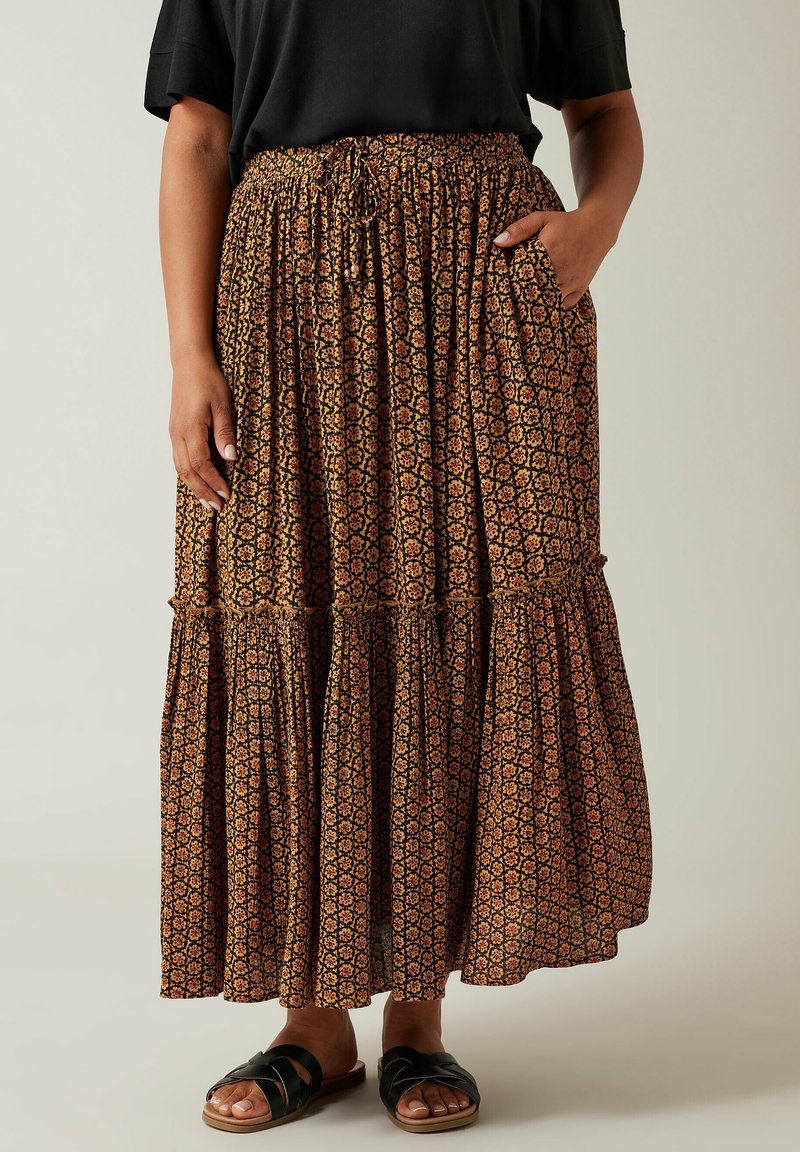 Maxi rok met bruin bloemenpatroon, elastische tailleband en gelaagd ontwerp. Gemaakt van lichte stof, met zijzakken.