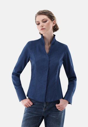 Navy blue blouse with a high collar, long sleeves, and a fitted silhouette. Textured fabric with a smooth finish.