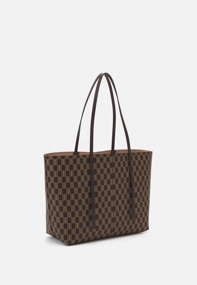 Brown patterned tote bag with rectangular shape, featuring two long shoulder straps. The design includes a repeated geometric pattern in gold.