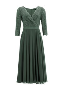 Robe verte avec un corsage en dentelle, des manches trois-quarts et une jupe plissée fluide. Encolure festonnée et détail de fermeture éclair dans le dos.