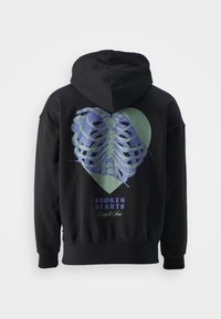 Black hoodie featuring a graphic of rib bones in blue and green heart shape with text "BROKEN HEARTS Only & Sons" at the bottom.