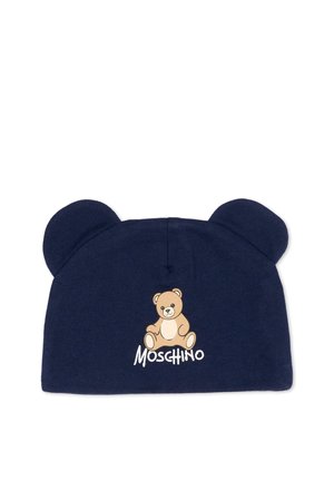 Bonnet bébé bleu marine avec des oreilles d'ours et un dessin d'ours en peluche au-dessus du nom de la marque Moschino sur le devant.