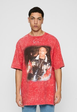 Red oversized t-shirt made of cotton featuring a graphic print on the front, depicting a person in a black leather jacket, with a marbled texture.