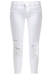 Jeans ajustados blancos con desgastes en la parte frontal, diseño de cinco bolsillos, cierre de botón y pasadores para cinturón. Elaborados en una mezcla de algodón.