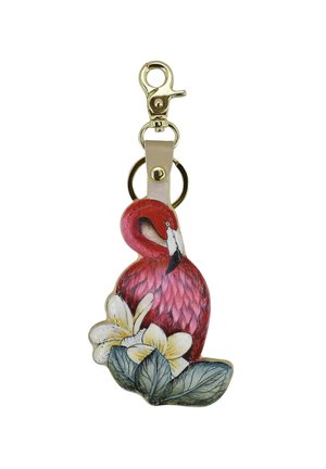 Red flamingo keychain made of painted metal, featuring yellow flowers and green leaves. It has a gold-tone clip and a leather strap.