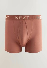 Boxer shorts en coton marron avec une ceinture élastique contrastante portant l'inscription "NEXT" en crème. Texture lisse avec une coupe ajustée.