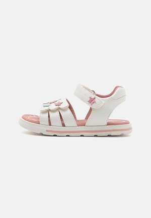 White sandals with adjustable strap, pink accents, and star-shaped decorations. Textured material and rubber sole for grip and comfort.