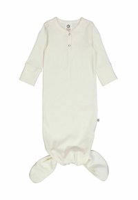 Krémový dětský spací overal vyrobený z měkké, žebrované látky. Má dlouhé rukávy, kulatý výstřih a uzlový spodek. Malá značková nášivka na boku.