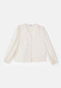 Blusa color avorio con maniche lunghe a sbuffo, scollatura a V e chiusura frontale con bottoni. Tessuto morbido, presenta una vestibilità comoda e cuciture delle spalle arricciate.