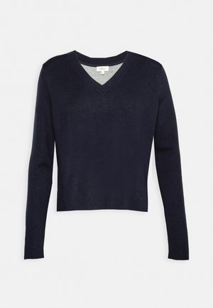 Marineblauwe gebreide pullover met lange mouwen en een V-hals. Vriendelijke textuur, cropped ontwerp en subtiele grijze binnenvoering bij de halslijn.