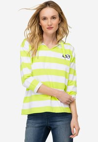 Hoodie a strisce verdi e bianche con scollo a V, maniche lunghe e coulisse; presenta un piccolo logo sul petto. Materiale in cotone morbido.