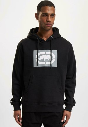 Black hoodie featuring a front kangaroo pocket, drawstring hood, and a gray graphic logo positioned centrally on the chest.
