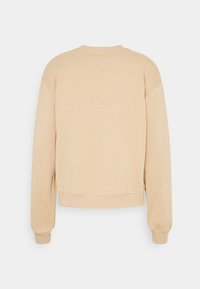 Felpa beige con scollo rotondo, maniche lunghe e polsini e orlo a coste. Il materiale sembra morbido e leggermente texturizzato.