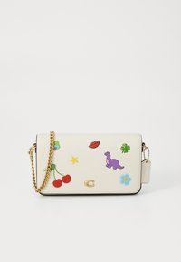 White faux leather handbag with gold chain strap, decorated with colorful patches including cherries, a dinosaur, and a flower.