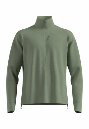 Pull-over en vert clair avec un col montant, fermeture à moitié zippée et tissu texturé. Équipé de zips latéraux et d'un design minimaliste.