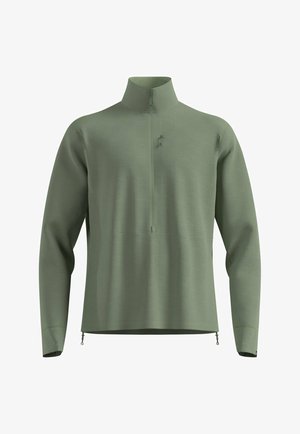 Pull-over en vert clair avec un col montant, fermeture à moitié zippée et tissu texturé. Équipé de zips latéraux et d'un design minimaliste.