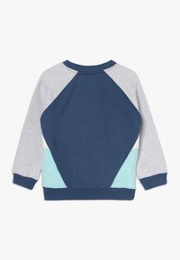 Navy and gray sweatshirt with raglan sleeves, featuring a teal panel and white accents. Soft cotton blend with a smooth texture.