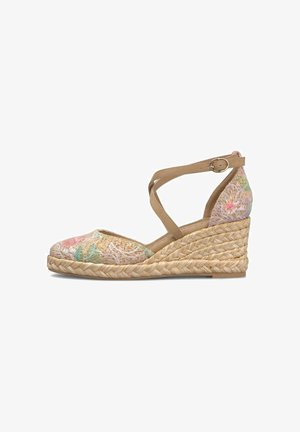 Scarpa espadrille con zeppa con tomaia in tessuto floreale, suola intrecciata in juta e cinturini incrociati color cuoio con fibbia intorno alla caviglia.