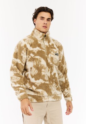 Fleece half-zip pullover in beige en crème, met een gestructureerd, fluffy oppervlak en een borstzak met een logo-tag.