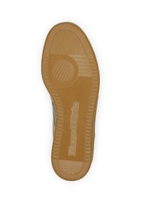 Semelle de chaussure en caoutchouc avec un motif texturé, présentant un accent circulaire et un logo. La couleur est un beige clair avec des détails nervurés.