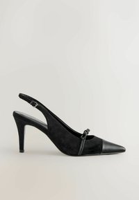 Pantof cu toc înalt slingback negru, cu vârful ascuțit, realizat din suede și accente din piele, având o curea subțire cu o cataramă decorativă.