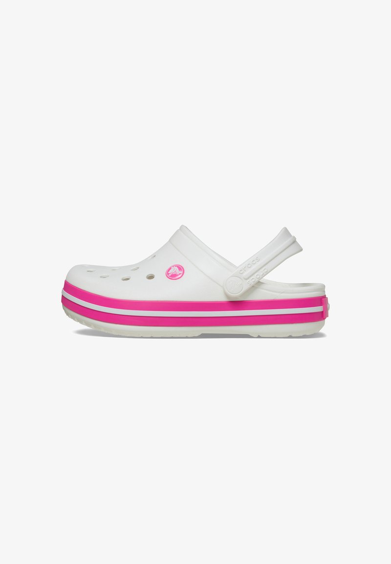 White Crocs clogs with a pink and white striped sole, featuring ventilation holes, a back strap, and a small logo emblem on the side.