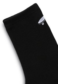 Schwarze Crew-Socke aus Baumwollmischung mit gerippter Textur. Kleines, weißes gesticktes Logo an der Seite und ein glatter oberer Rand.