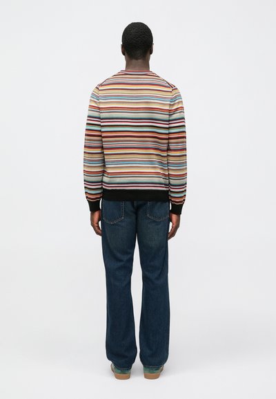 Maglione a righe multicolore con polsini e orlo a coste, abbinato a jeans denim blu a gamba dritta. Design semplice, vestibilità casual.