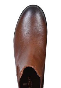 Brązowy skórzany but z zaokrąglonym noskiem i elastycznymi wkładkami po bokach. Teksturowana powierzchnia i lekko błyszczące wykończenie. Niskoprofilowa czarna podeszwa.