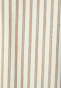 Bawełniana tkanina o teksturowanej powierzchni, z pionowymi paskami w kolorze delikatnego brzoskwiniowego i ciemnoniebieskiego na kremowym tle.