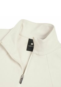 White quarter-zip fleece jacket with a high collar and visible Luhta brand tag inside the neckline.