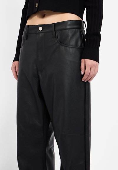 Black leather pants featuring a smooth texture, side pockets, and a silver button closure at the waist; relaxed fit.