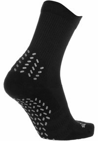 Black ankle sock with ribbed texture and sticky gray grip dots on the sole, designed for traction and comfort in movement.